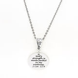 May include: A silver necklace with a round pendant that reads &#39;God&#39;s strength is made perfect in my weakness. 2 Cor. 12:9&#39;.