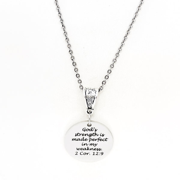 May include: A silver necklace with a round pendant that reads &#39;God&#39;s strength is made perfect in my weakness. 2 Cor. 12:9&#39;.